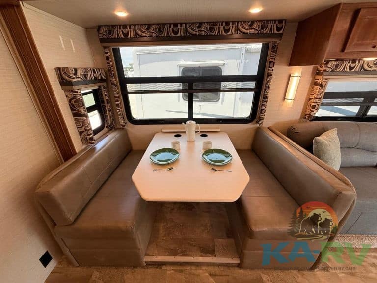 RV dining area with large window and cozy seating for optimal comfort and style.