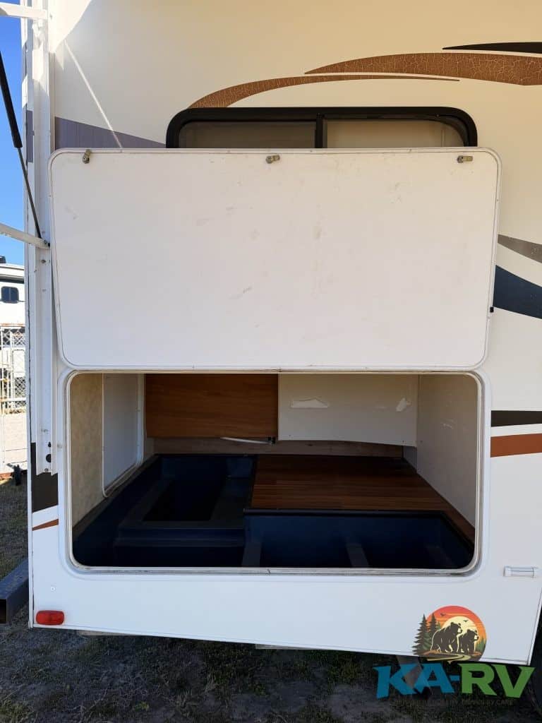 Open storage compartment of 2013 Coachmen Freelander RV for optimal space utilization.