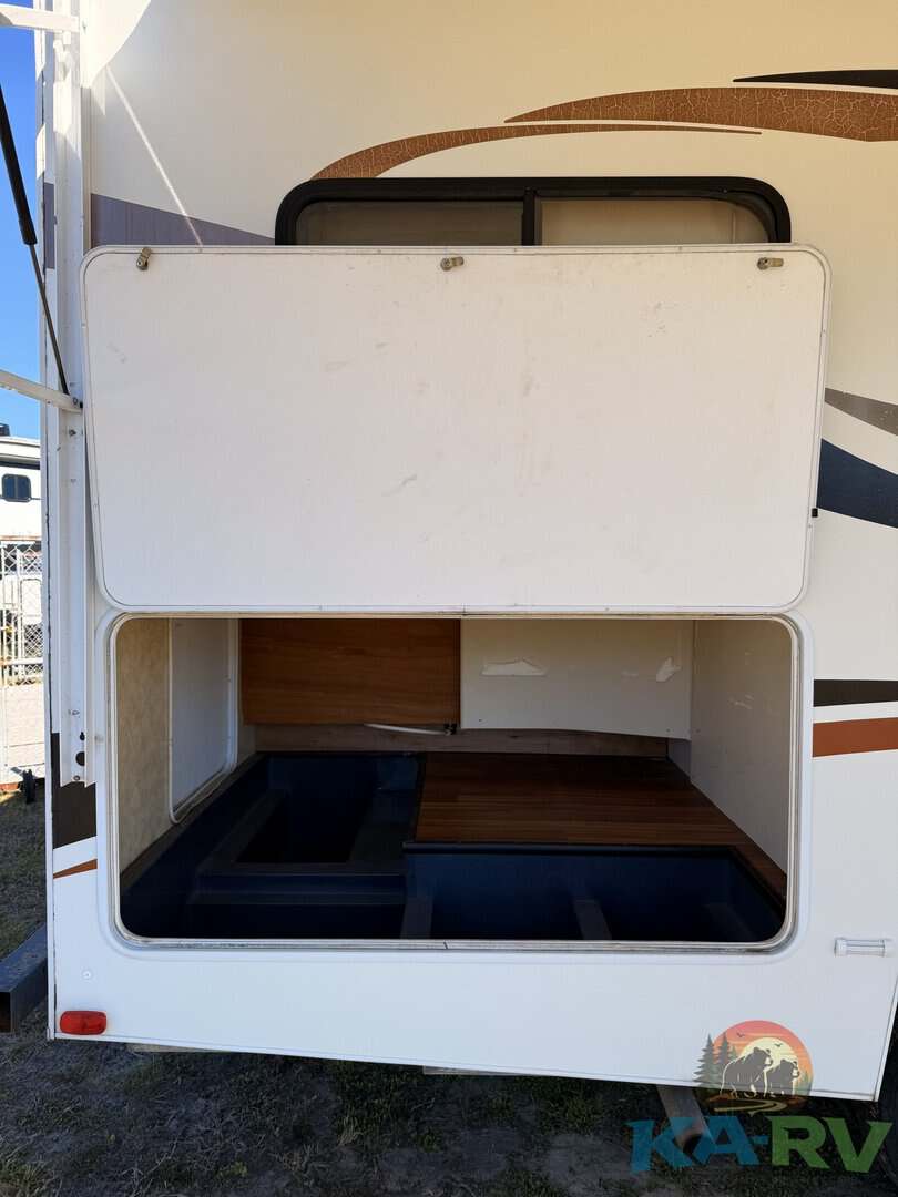 Open storage compartment of 2013 Coachmen Freelander RV for optimal space utilization.