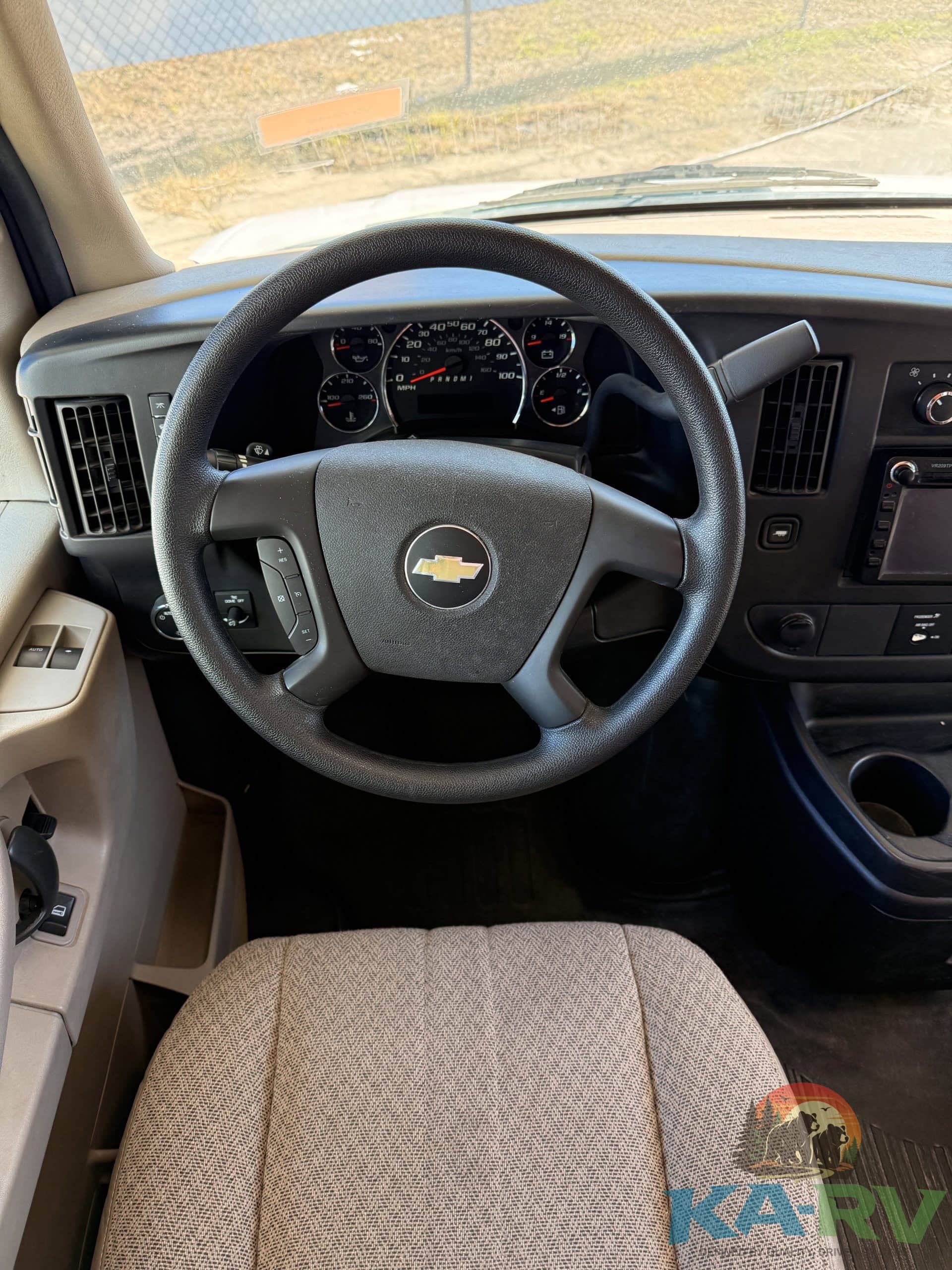View of the steering wheel and dashboard inside a 2013 Coachmen Freelander RV.