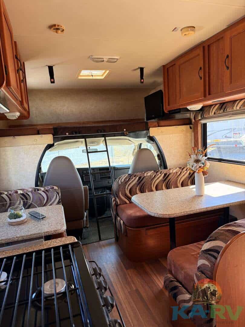 Accessible RV interior with cozy seating and dining area.