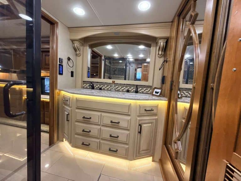 Interior view of 2016 Entegra Cornerstone 45B RV with cabinetry and lighting.