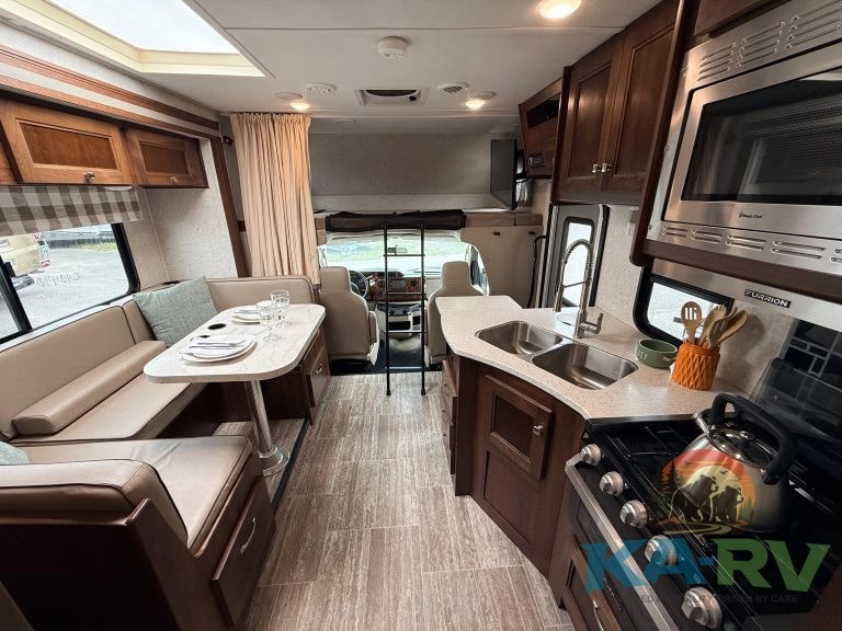 Cozy RV interior with kitchen, dining, and sleeping areas in a 2019 Forester model.