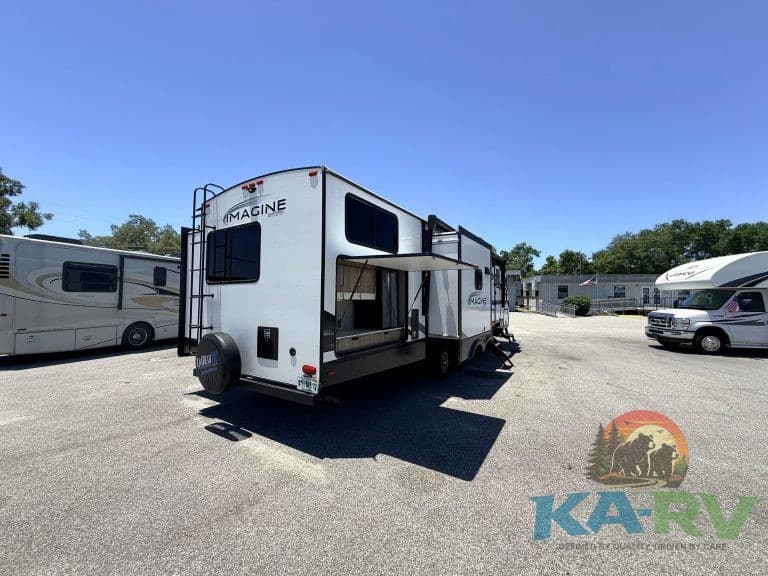 RV with slide-out extension parked in an outdoor lot.