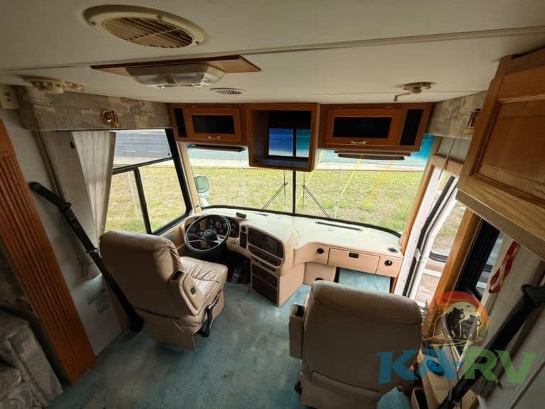 RV dashboard and driver seats inside a motorhome at Karv Repair.