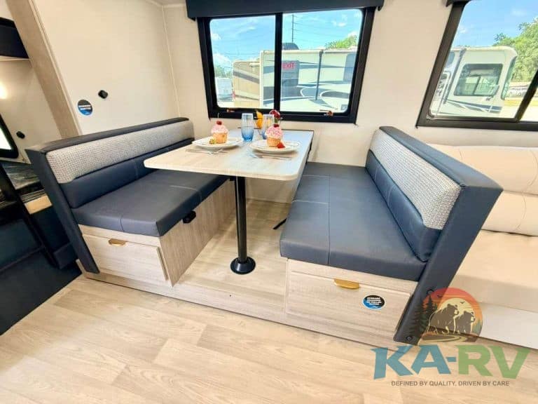 RV dining area with booth seating and table in 2026 Acclaim 2700BH.