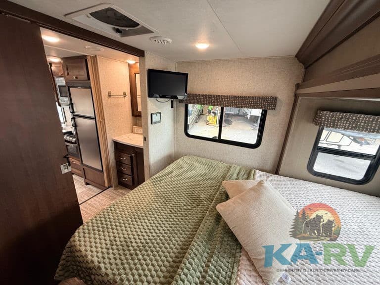 Cozy bedroom inside 2019 Forest River Forester RV for optimal travel comfort.