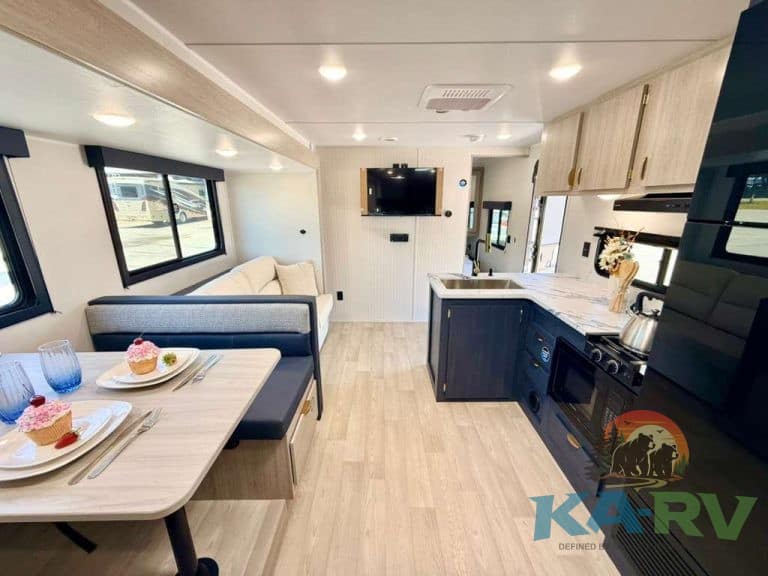 Modern RV interior with kitchen and dining area for 2026 Acclaim 2700BH.