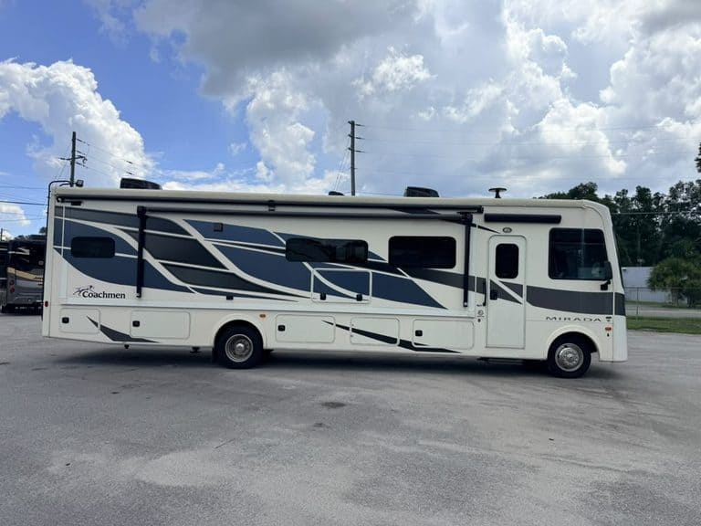 Side view of 2023 Coachmen Mirada 35OS motorhome in parking lot.