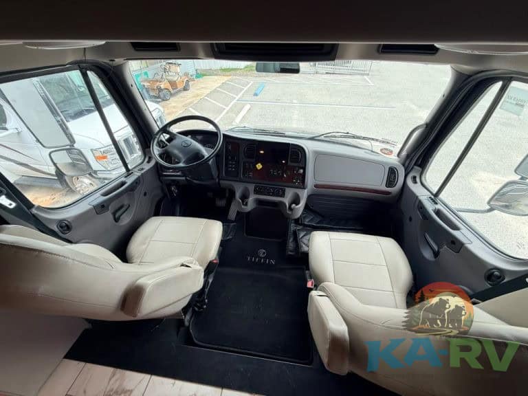 RV dashboard and front seats in a 2025 Tiffin Allegro Bay 38AB.