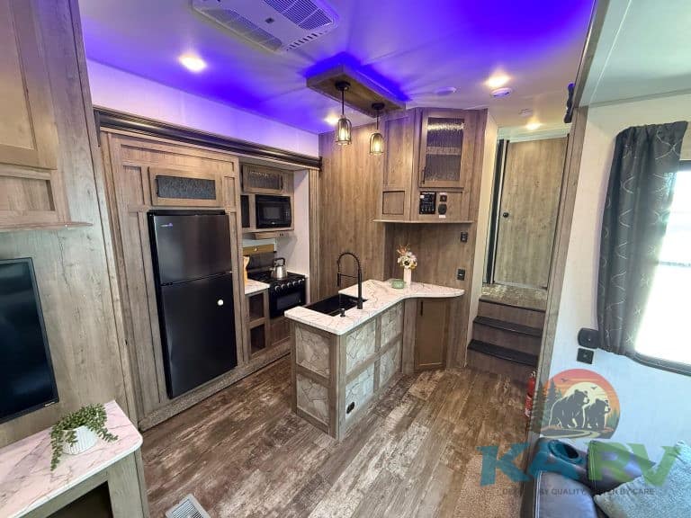 Interior view of a 2021 Forest River Cherokee Wolf Pack 325PACK13 RV kitchen.