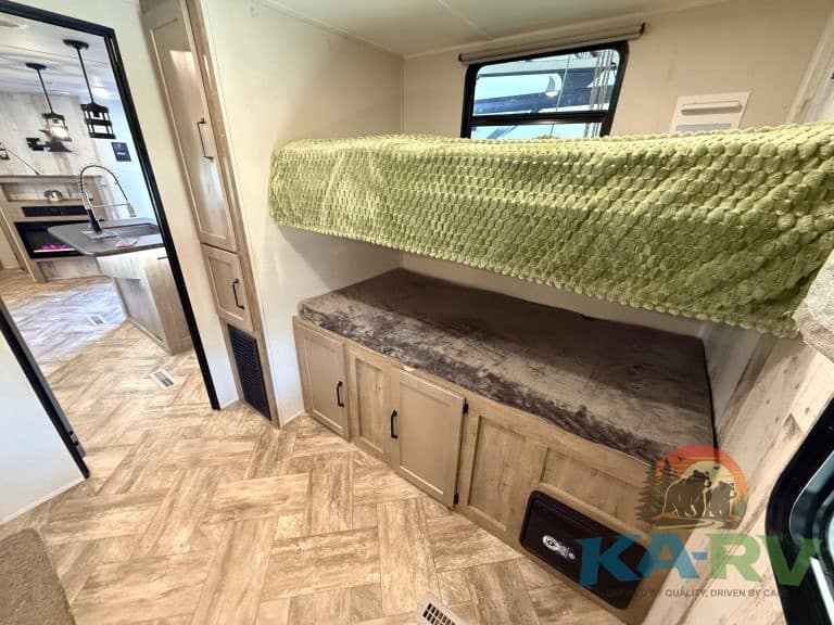RV interior with bunk beds and storage cabinets for optimal space utilization.