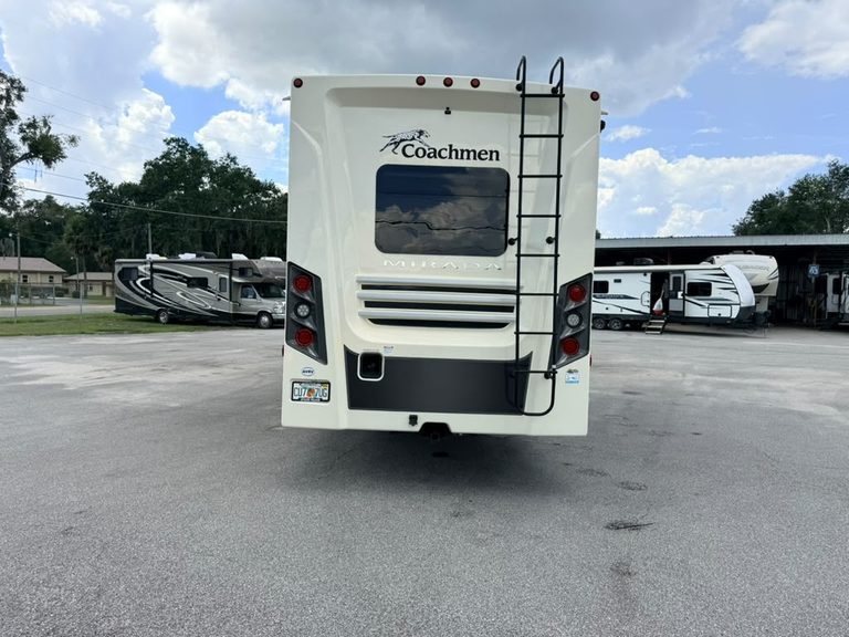 Rear view of Coachmen Mirada 35OS RV with ladder and windows.