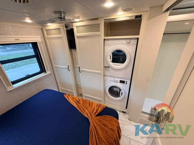 Interior of a 2025 Tiffin Allegro Bay RV with washer and dryer.