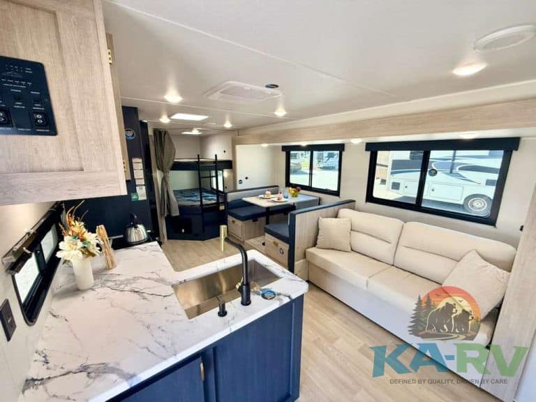 Modern RV interior with kitchen and living area in 2026 Acclaim 2700BH.
