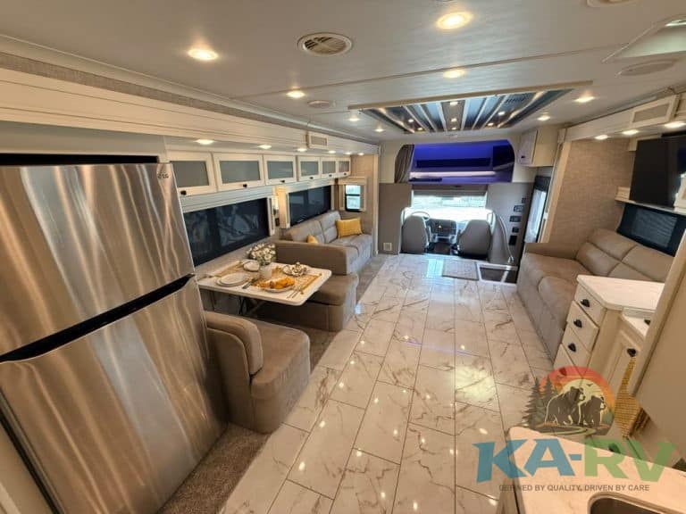 Luxury RV interior with modern furnishings and kitchen area.