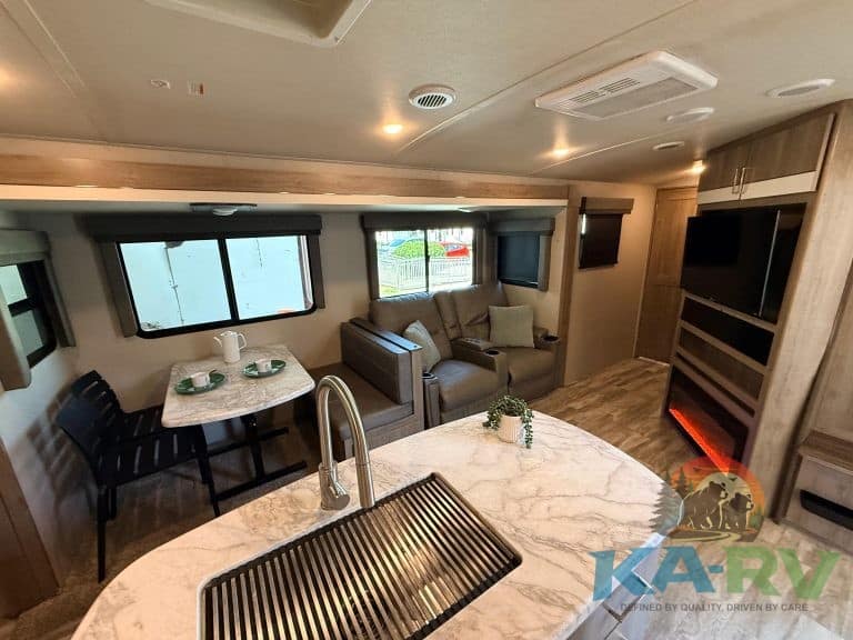 RV interior with comfortable seating, modern kitchen, and entertainment area for optimal travel expe.