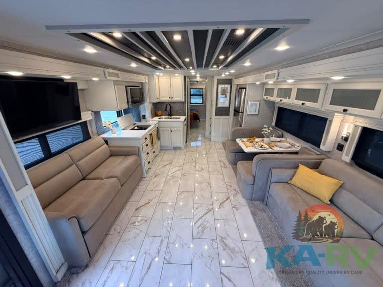 Spacious RV interior with modern furnishings and lighting.