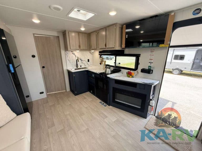 Interior of 2026 Acclaim 2500RD RV with kitchen and seating area.