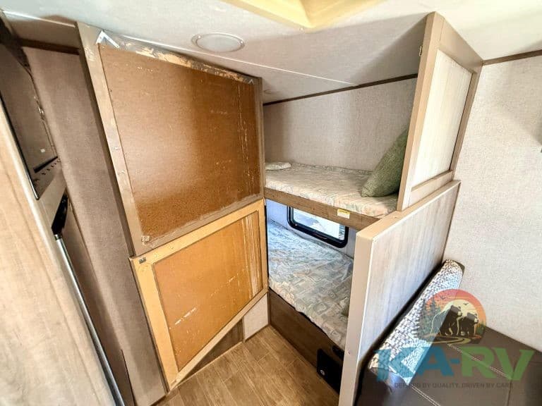 RV bunk bed with storage compartments for efficient space use.