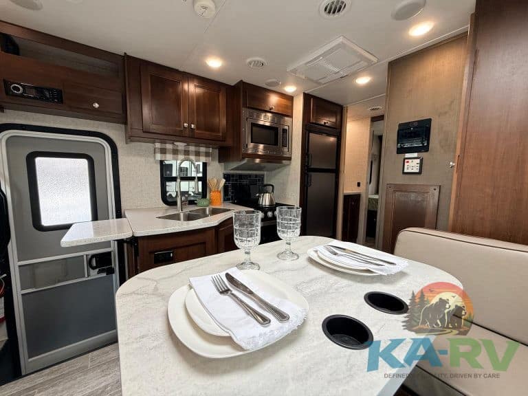 RV kitchen and dining space featuring modern cabinetry and amenities.