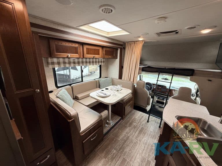 RV interior with dining and driving area in a Forest River Forester 2501TS.
