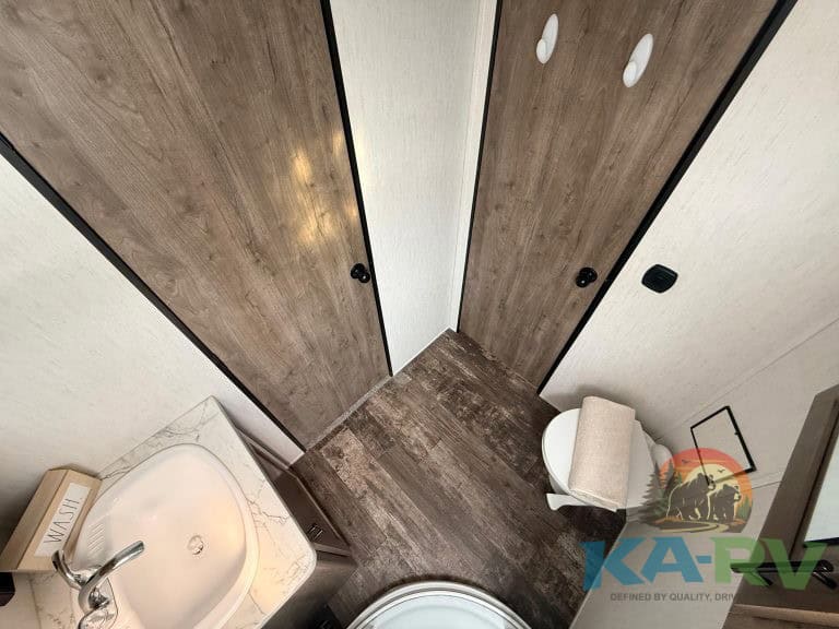 RV interior storage and bathroom in a 2021 Forest River Cherokee Wolf Pack 325PACK13.