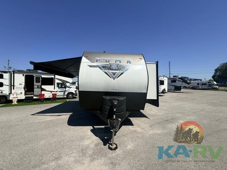 Modern Puma RV trailer with outdoor awning, ideal for camping and travel. Perfect for Optima and RV.