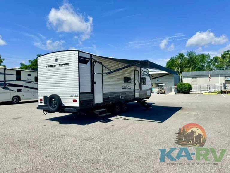 Modern RV parked in lot with blue sky and trees, for 2026 Acclaim 2700BH model.