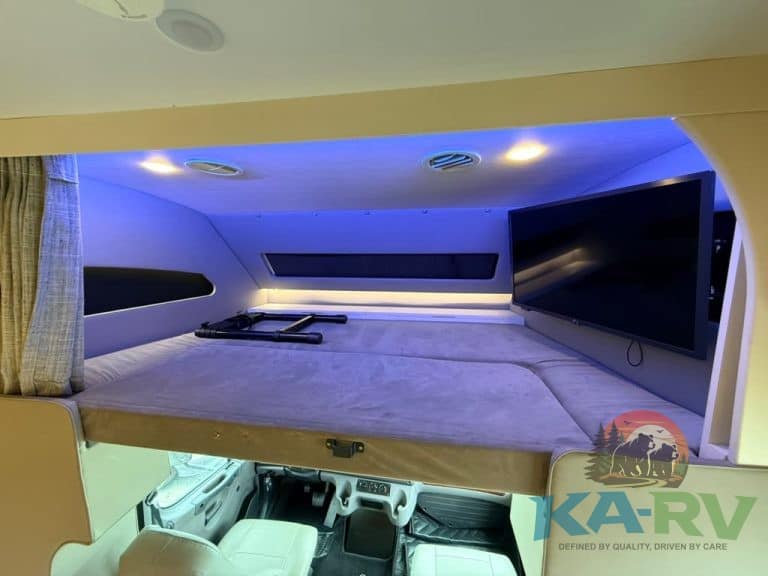 Luxury RV interior with LED lighting and entertainment system.