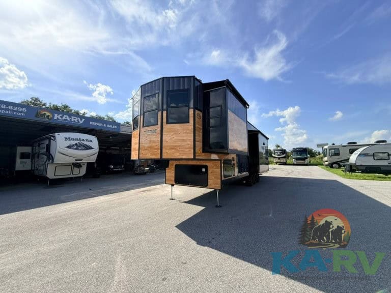 Contemporary Cedar Creek Cottage 41 FWC RV with wood accents and large windows.