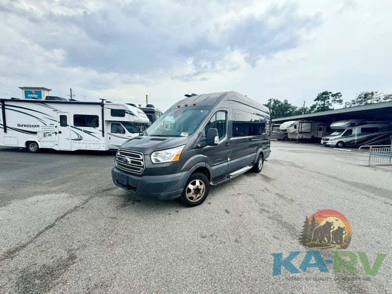 Custom van parked at KA RV Repair with RVs in background.