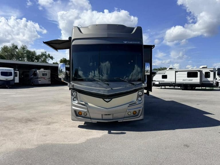 Front view of a 2018 Fleetwood Discovery 40X LXE RV in a dealership lot.