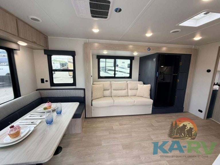 Modern RV interior with sofa and dining area in 2026 Acclaim 2500RD.