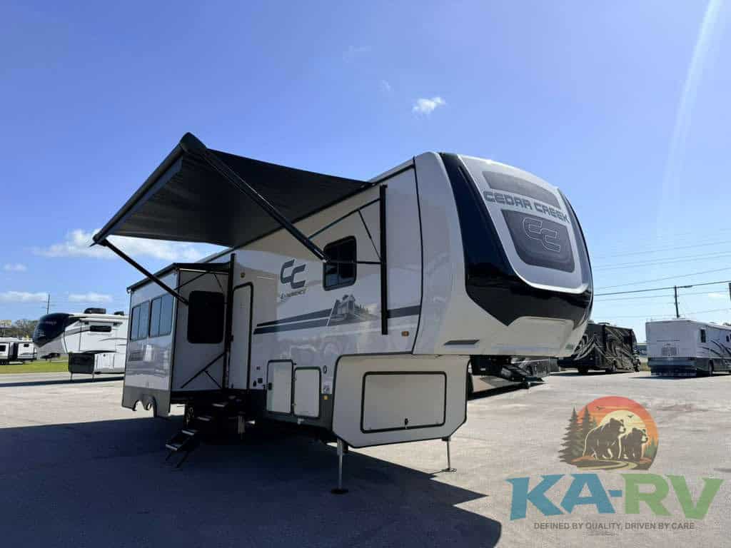 Modern RV travel trailer with awning and slide-out for camping trips.