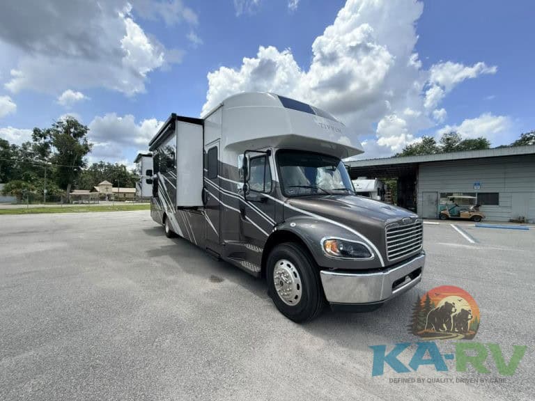 Luxury RV Tiffin Allegro Bay 38AB parked in lot under blue sky.