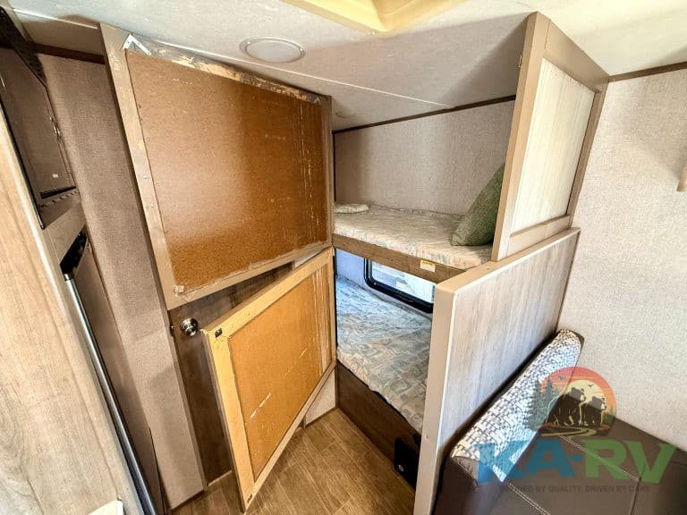 RV bunk bed with foldable privacy panels and comfortable sleeping space.