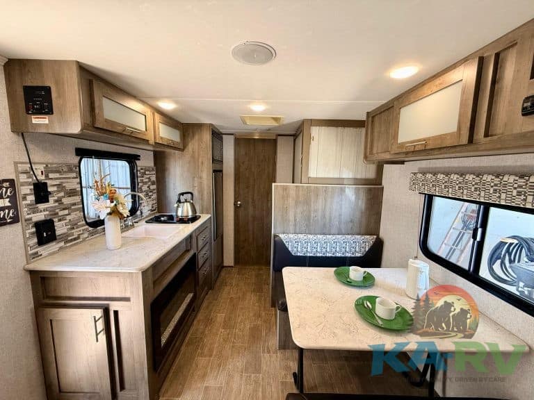 RV kitchen interior with modern cabinetry and appliances for optimal travel comfort.