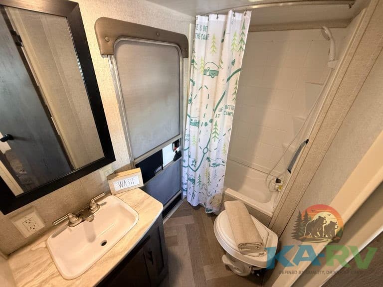 RV bathroom with shower, toilet, and sink for optimal comfort and convenience.