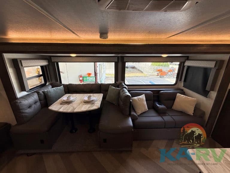 RV interior with spacious lounge and dining area for travel comfort.