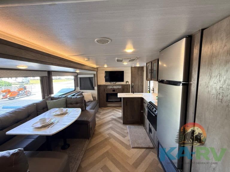 RV interior with kitchen, dining, and living space for travel comfort and convenience.