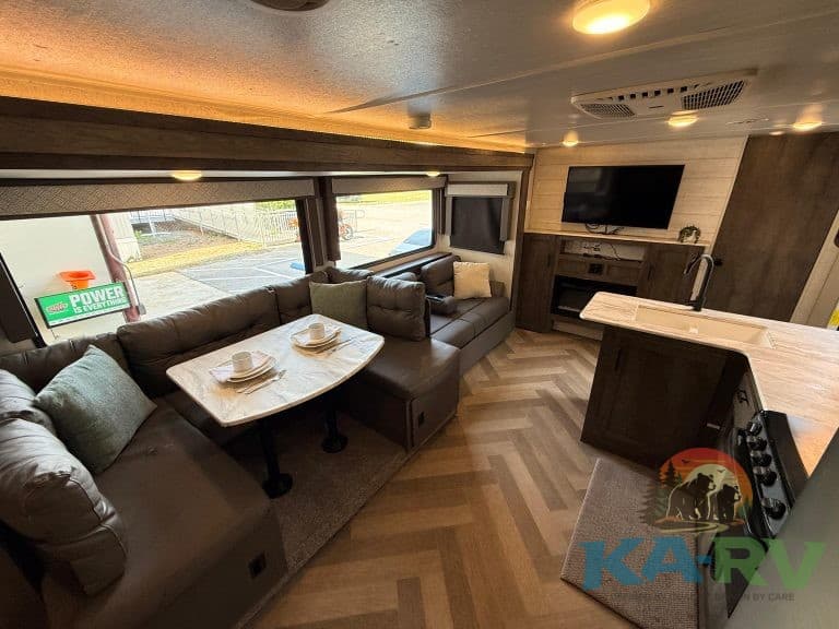 RV interior with cozy seating and modern amenities for optimal travel comfort.