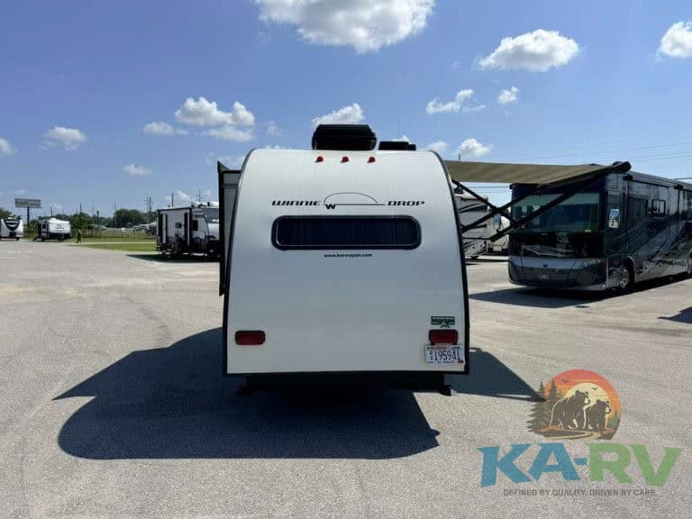 Rear view of 2017 Winnebago Winnie Drop RV in outdoor lot.