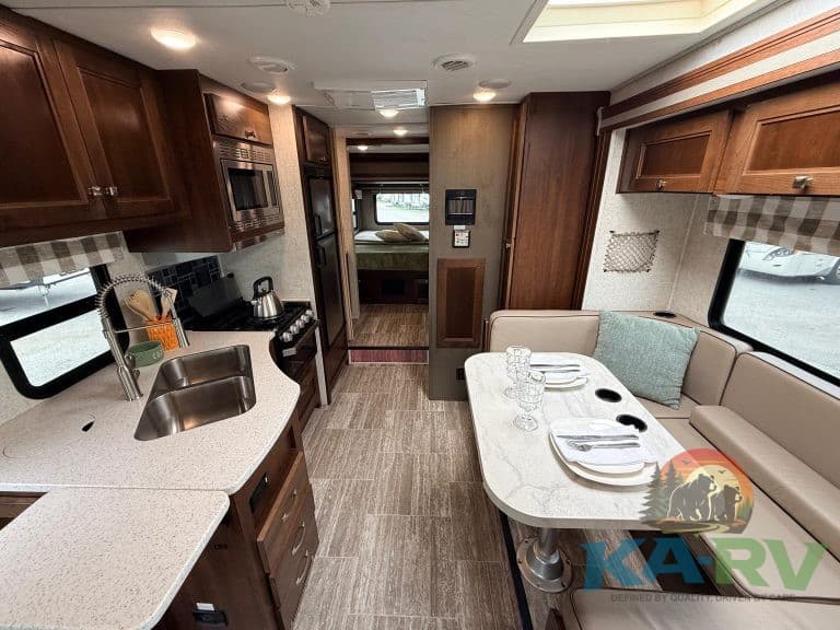 Interior view of a 2019 Forest River Forester RV showing kitchen and dining area.