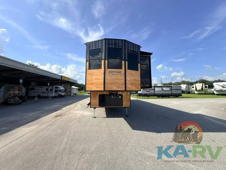 Modern Cedar Creek Cottage 41 FWC travel trailer in outdoor lot.
