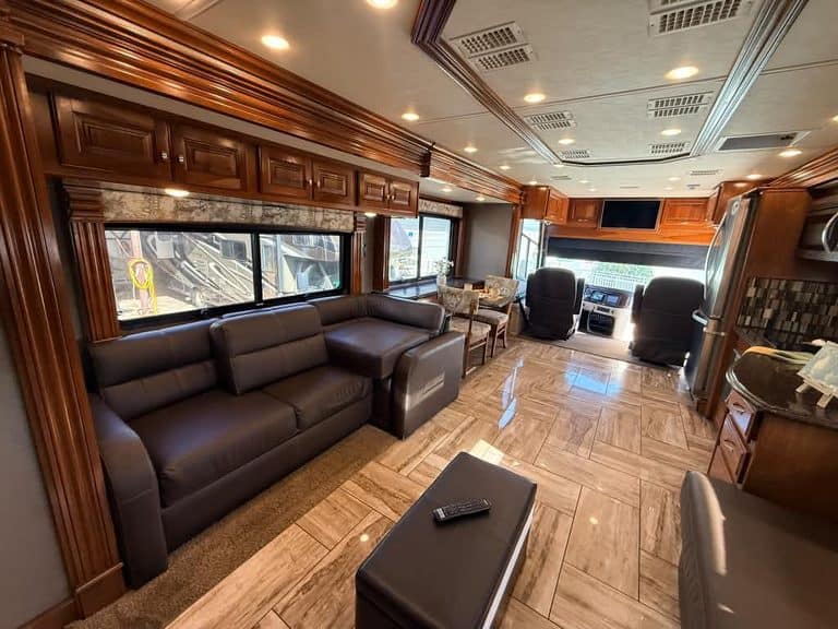 Spacious RV living area with leather sofa and modern amenities.