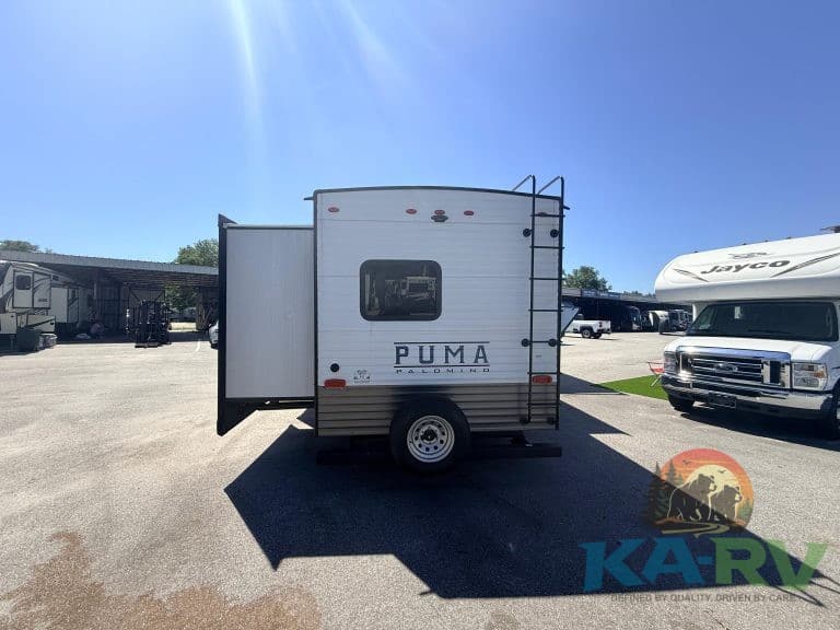 Portable RV travel trailer with slide-out and window, ideal for camping and travel.
