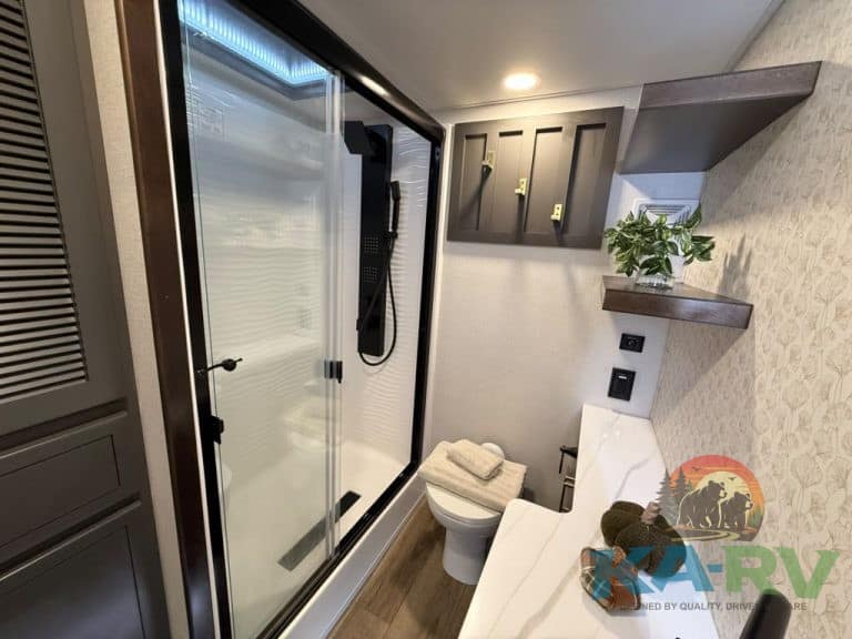 Modern bathroom with shower, toilet, and storage shelves in Cedar Creek Cottage 41 FWC.
