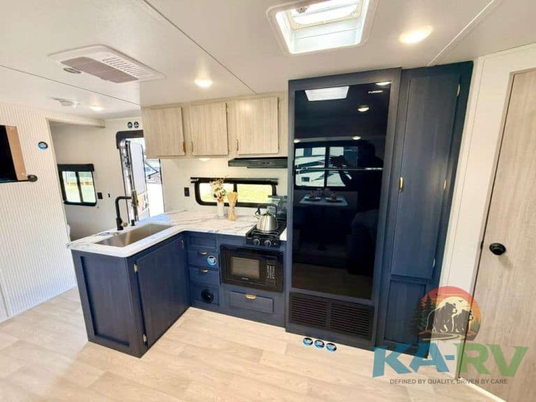 Interior of 2026 Acclaim 2700BH RV with kitchen and storage.