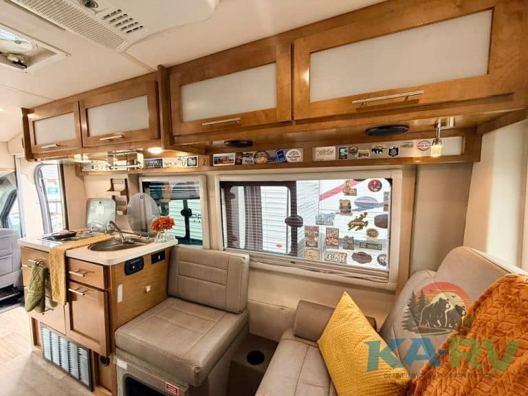 RV interior with cabinetry, seating, and window view.